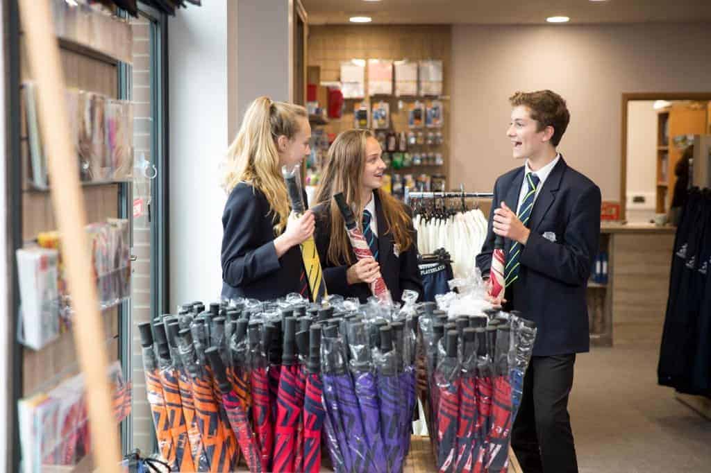eastbourne-college-college-life-school-shop-pupils-with-umbrellas-1024x682